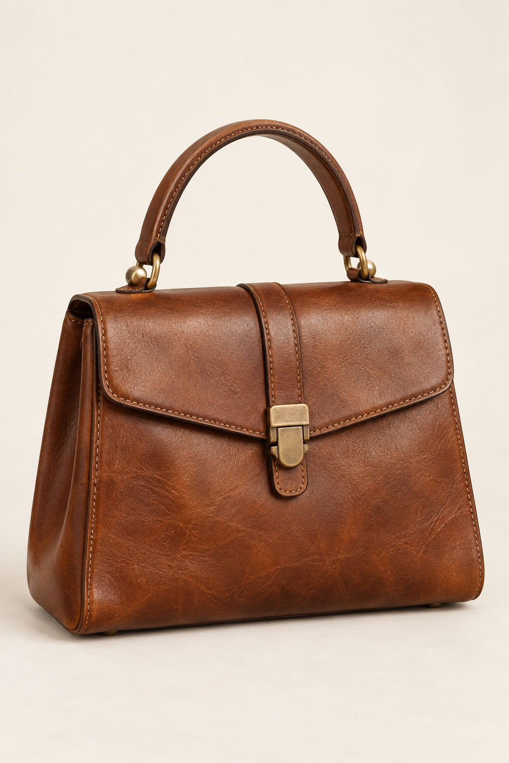 Brown leather vintage top-handle bag on a light background